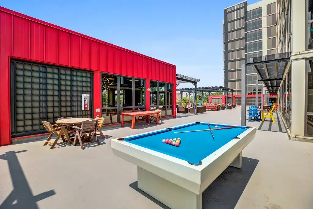 Outdoor rooftop lounge with a pool table at Vista Denver university of denver housing POI 011